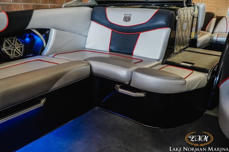 Slide: The Image of 2014 MasterCraft XStar interior seating with red and black accents at Lake Norman Marina. - 18