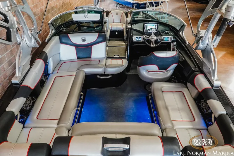 Slide: The Image of 2014 MasterCraft XStar interior with spacious seating and modern dashboard at Lake Norman Marina. - 9