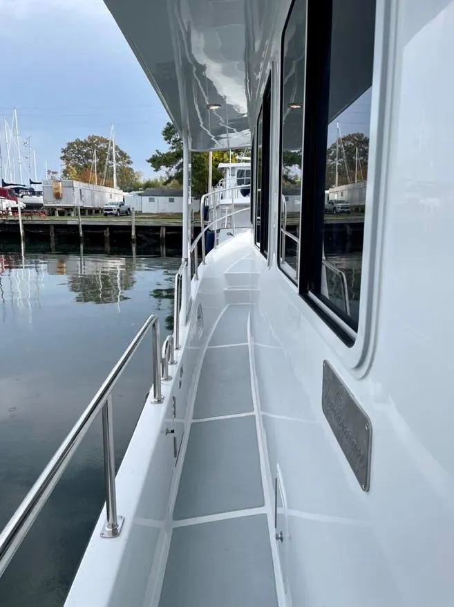 Slide: The Image of Side deck of 2024 Helmsman Trawlers 38 Sedan at dock. - 13