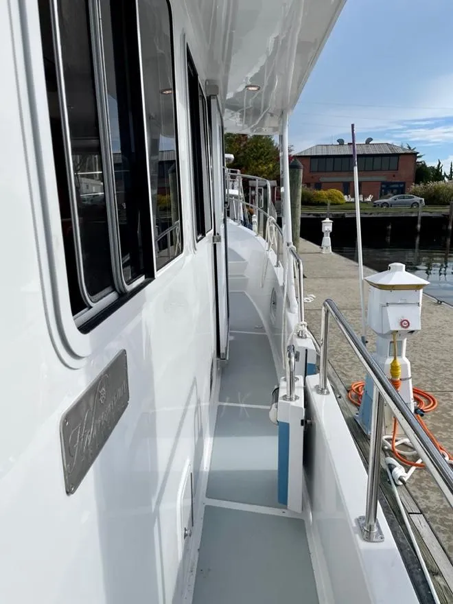 Slide: The Image of Side deck of 2024 Helmsman Trawlers 38 Sedan at dock. - 14