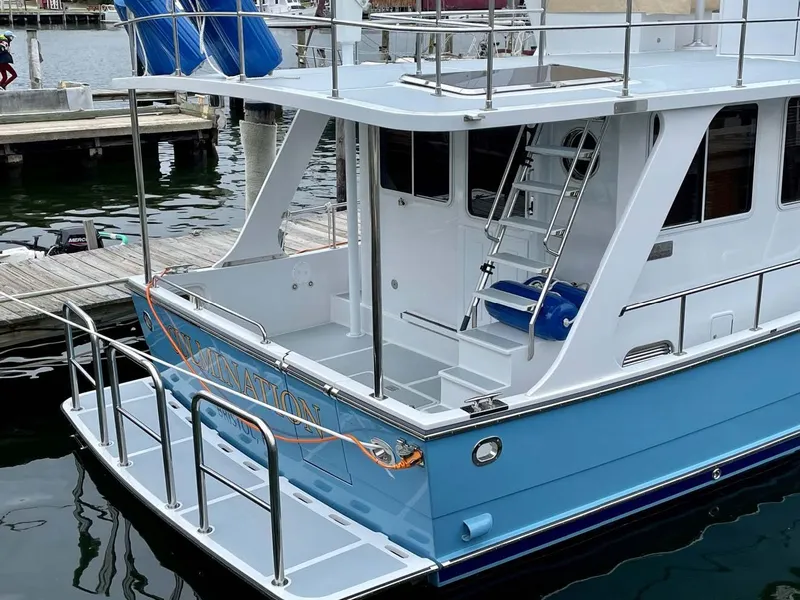 Slide: The Image of Helmsman Trawlers 38 Sedan 2024 at dock, blue and white paint. - 15