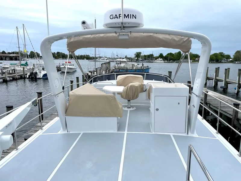 Slide: The Image of Helmsman 38 Sedan 2024 at a serene harbor dock. - 16