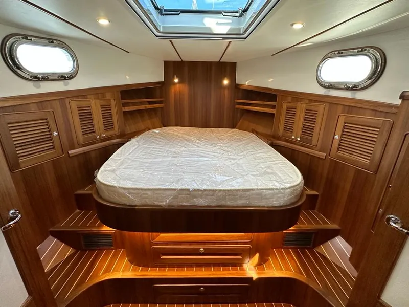 Slide: The Image of 2024 Helmsman 38 Sedan interior with luxurious wood finish. - 6
