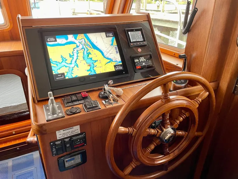 Slide: The Image of Helmsman Trawlers 38 Sedan 2024 helm with navigation system. - 9