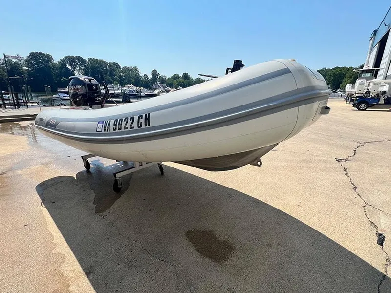 Slide: The Image of 2021 AB Inflatables AB 11 boat on a trailer in a marina. - 2