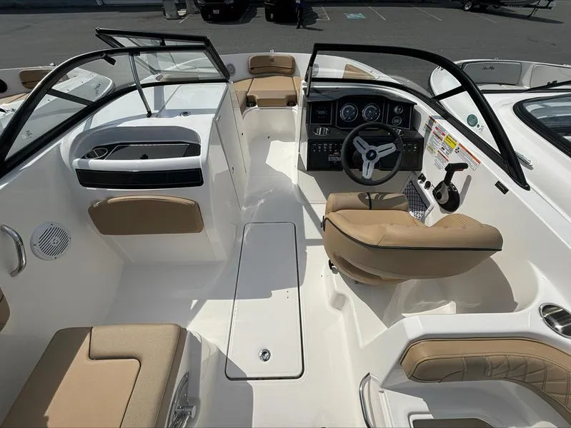 Slide: The Image of 2024 Bayliner VR6 boat interior with beige seating and modern dashboard. - 10