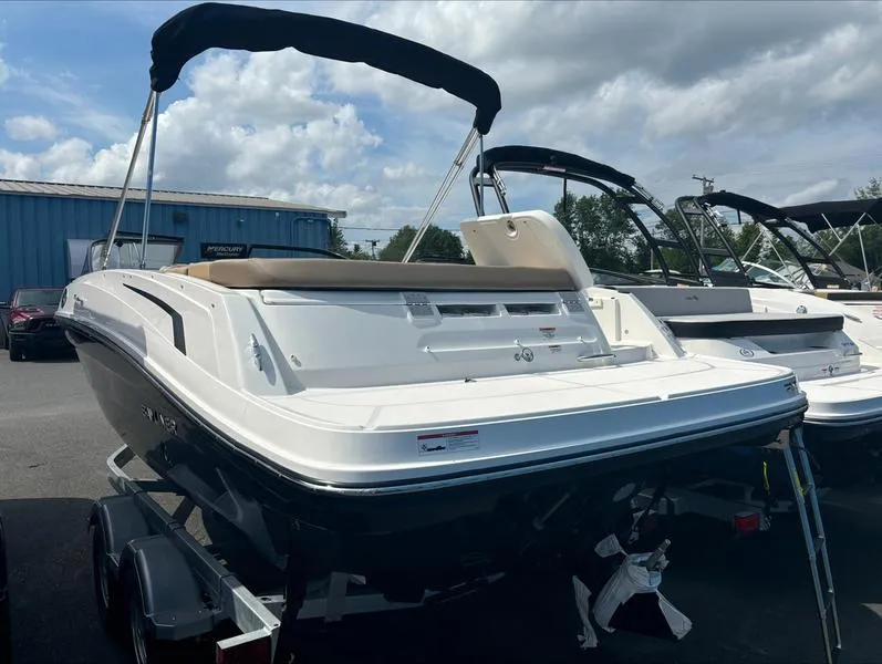Slide: The Image of 2024 Bayliner VR6 boat with canopy on trailer, parked outdoors. - 5