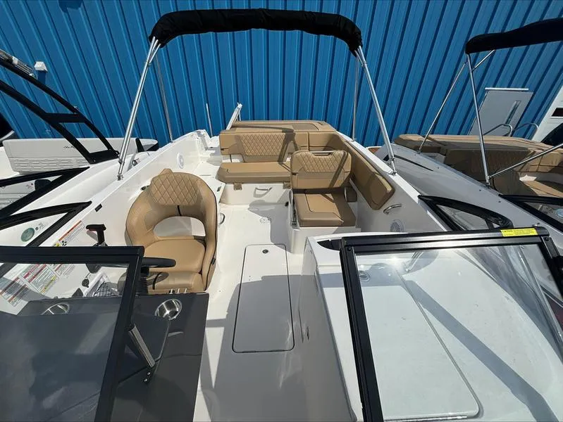 Slide: The Image of 2024 Bayliner VR6 boat with tan seating and black canopy. - 7