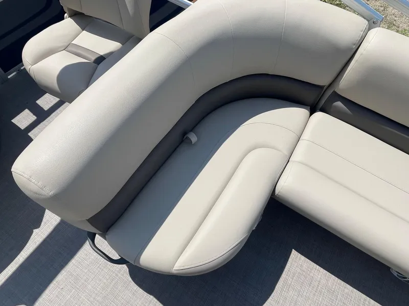 Slide: The Image of 2024 Sun Tracker Bass Buggy 18 DLX pontoon boat with beige cushioned seating. - 17