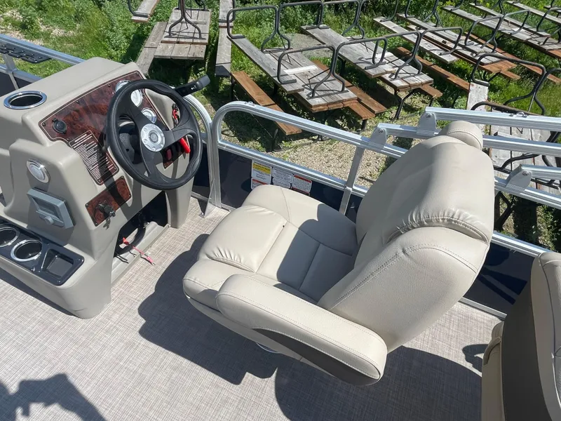 Slide: The Image of 2024 Sun Tracker Bass Buggy 18 DLX captain's chair and helm station. - 19