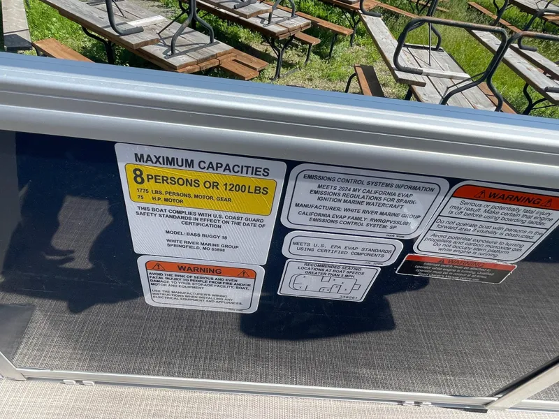 Slide: The Image of 2024 Sun Tracker Bass Buggy 18 DLX capacity and safety labels, 8 persons or 1200 lbs limit. - 20