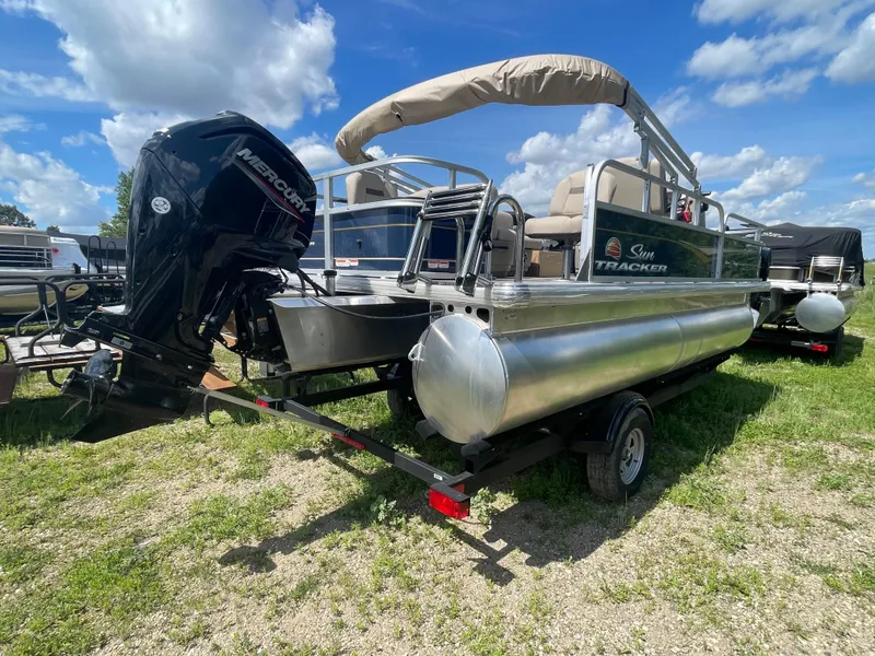 Slide: The Image of 2024 Sun Tracker Bass Buggy 18 DLX pontoon boat with Mercury outboard motor. - 3