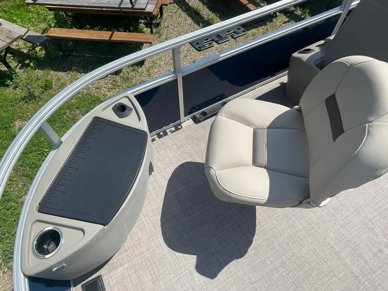 Slide: The Image of 2024 Sun Tracker Bass Buggy 18 DLX boat interior with seating and storage. - 7