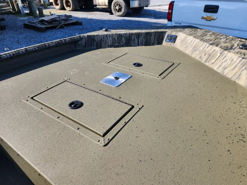 Slide: The Image of 2024 SeaArk 1960 Slayer Pro boat deck with storage compartments. - 4