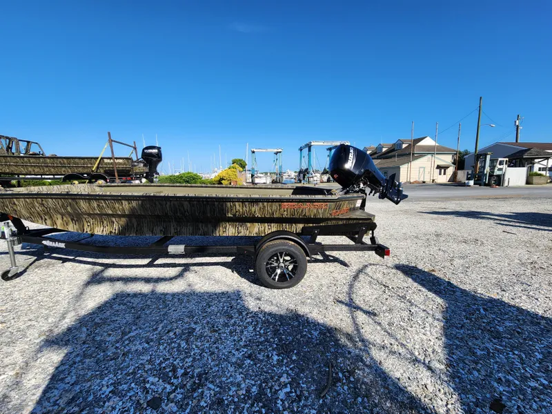 Slide: The Image of 2024 SeaArk 1960 Slayer Pro boat on trailer in marina. - 5