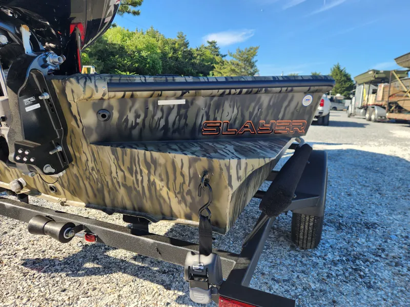 Slide: The Image of 2024 SeaArk 1960 Slayer Pro boat rear view with camouflage design. - 7