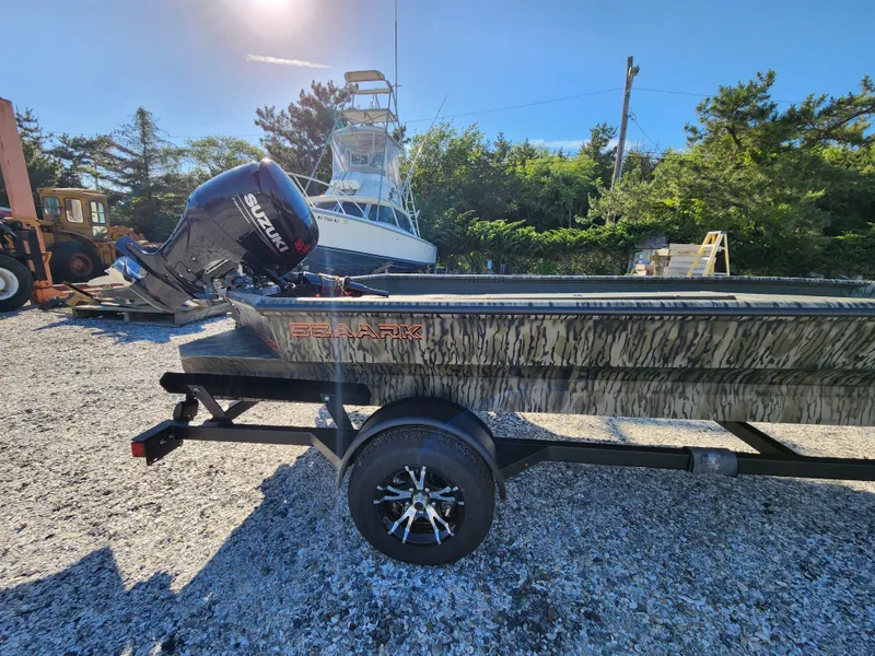 Slide: The Image of 2024 SeaArk 1960 Slayer Pro boat on trailer with Suzuki outboard motor. - 8