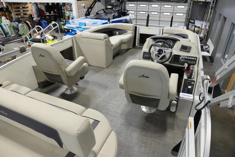 Slide: The Image of 2024 Barletta ARIA A20UC pontoon boat interior with beige seating and modern helm. - 11