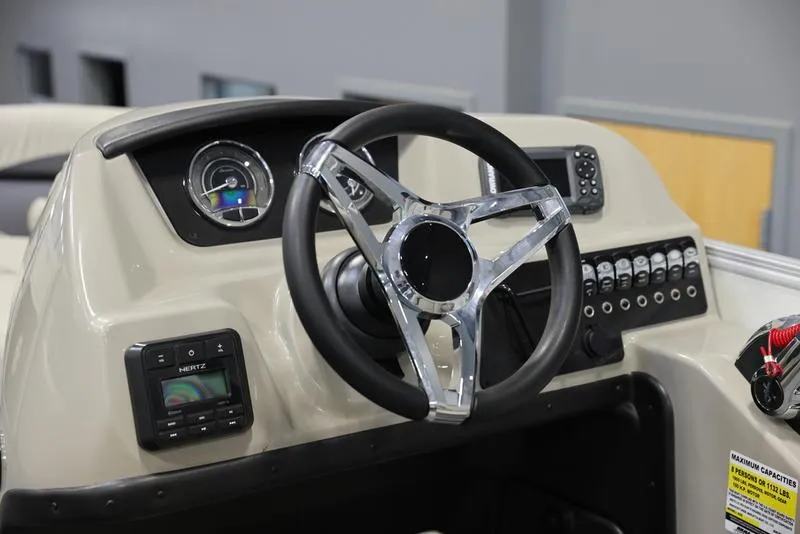 Slide: The Image of 2024 Barletta ARIA A20UC boat dashboard with steering wheel and control panel. - 2
