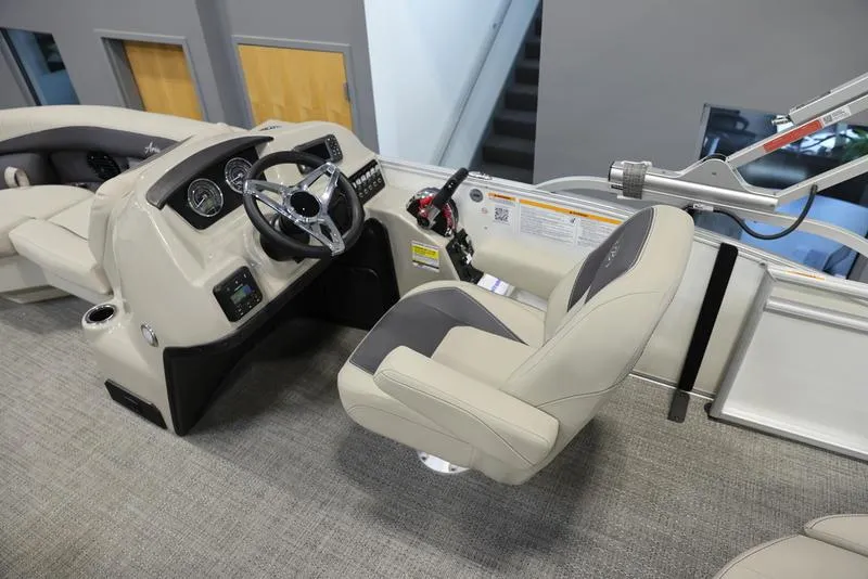 Slide: The Image of 2024 Barletta ARIA A20UC boat cockpit with steering wheel and captain's chair. - 3