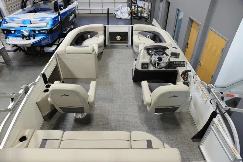 Slide: The Image of 2024 Barletta ARIA A20UC pontoon boat interior with beige seating and modern helm. - 5