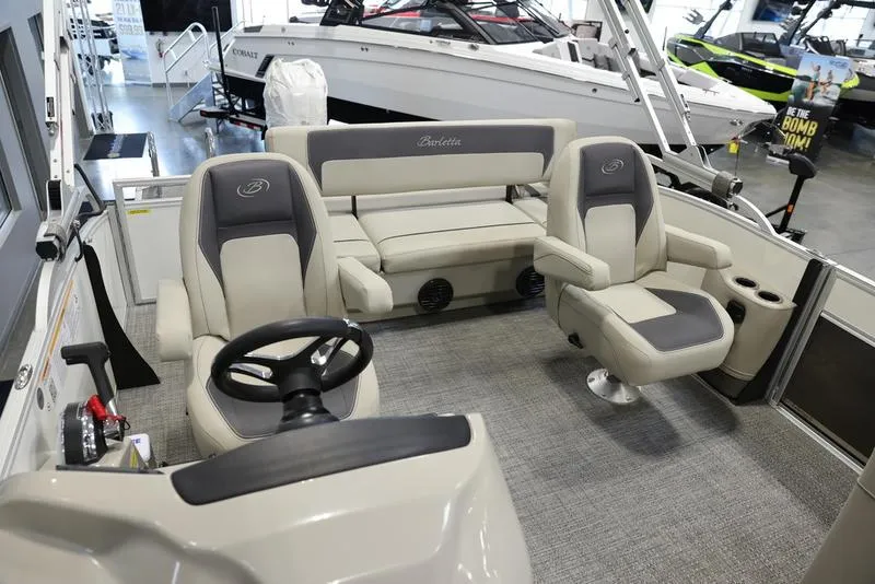 Slide: The Image of 2024 Barletta ARIA A20UC pontoon boat interior with helm, seating, and steering wheel. - 9