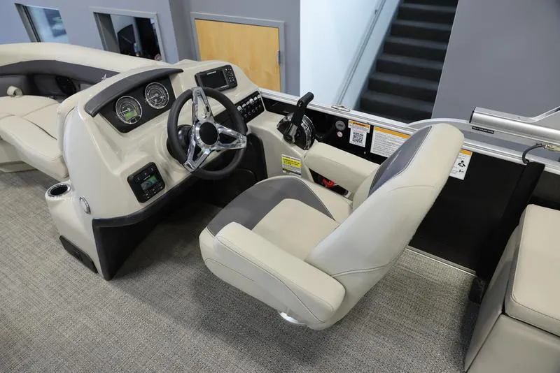 Slide: The Image of 2024 Barletta Aria A22CC boat cockpit with steering wheel and captain's chair. - 12