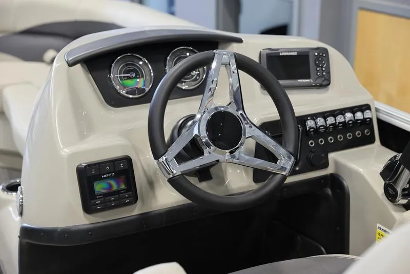 Slide: The Image of 2024 Barletta Aria A22CC boat dashboard with steering wheel and control panel. - 13