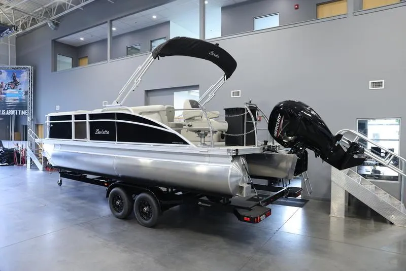 Slide: The Image of 2024 Barletta Aria A22CC pontoon boat on a trailer in a showroom. - 18