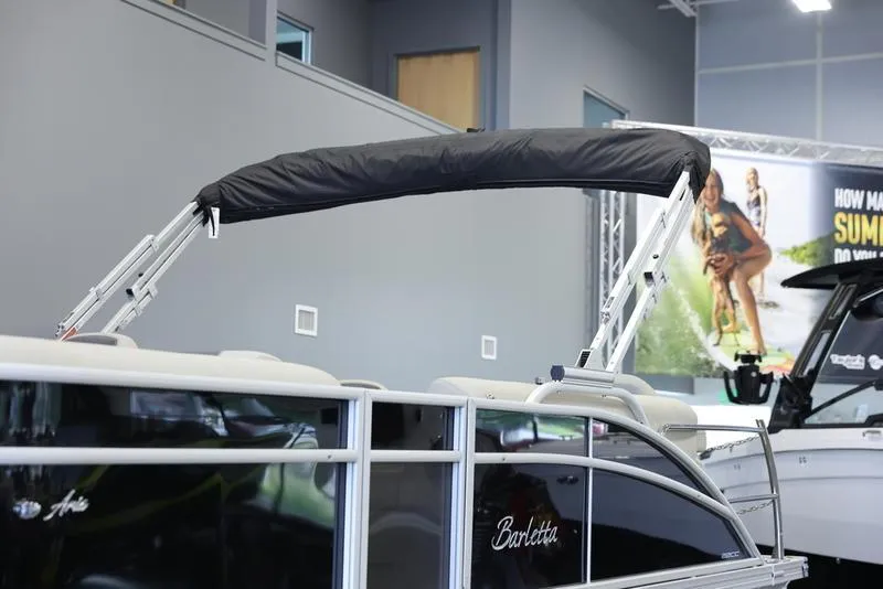 Slide: The Image of 2024 Barletta Aria A22CC pontoon boat on display in showroom. - 3