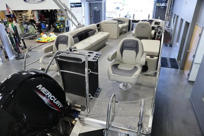 Slide: The Image of 2024 Barletta Aria A22CC pontoon boat interior with Mercury engine in showroom. - 5