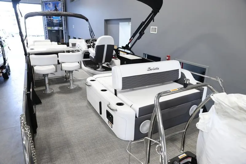 Slide: The Image of 2024 Barletta CORSA 25UE pontoon boat interior with white seating and modern design. - 10