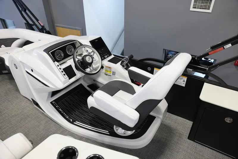 Slide: The Image of 2024 Barletta CORSA 25UE boat cockpit with modern steering console and comfortable seating. - 11