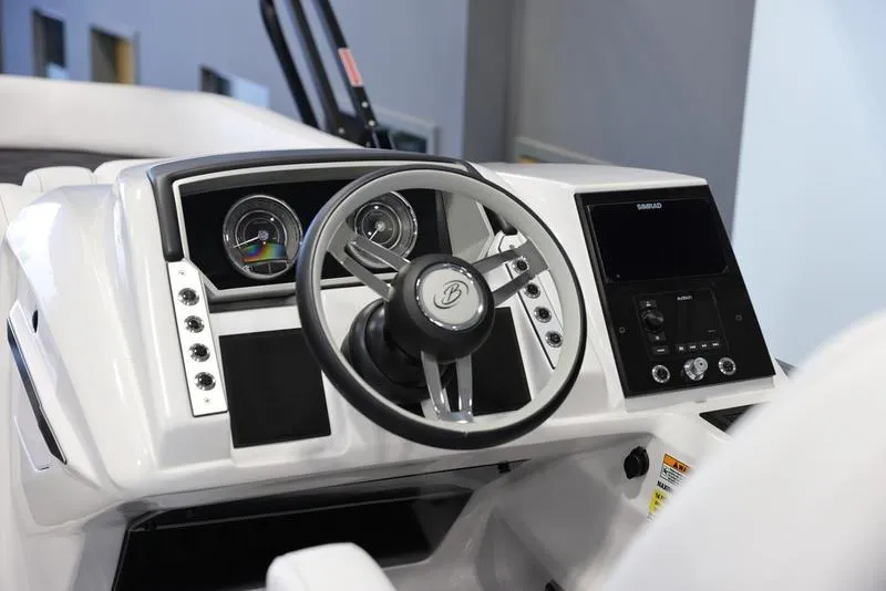 Slide: The Image of 2024 Barletta CORSA 25UE boat dashboard with steering wheel and control panel. - 12