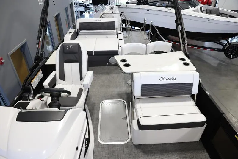 Slide: The Image of 2024 Barletta CORSA 25UE pontoon boat interior with seating and helm station. - 15