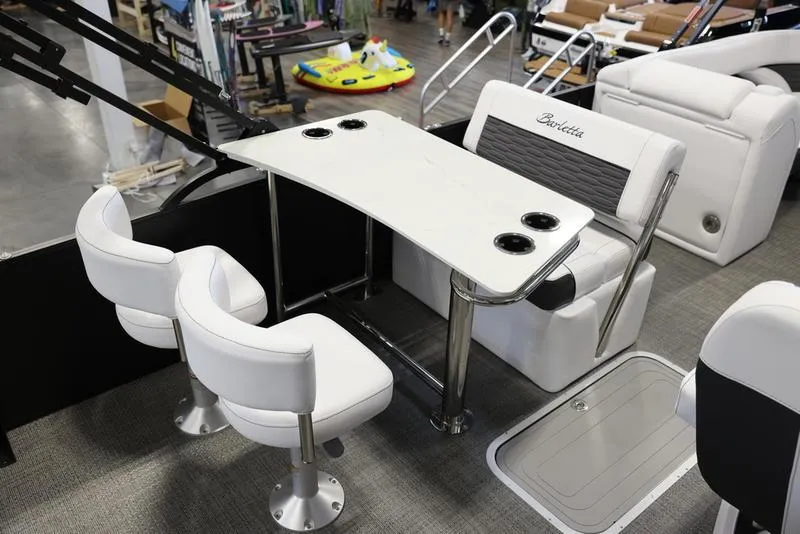 Slide: The Image of 2024 Barletta CORSA 25UE boat interior with white seating and table. - 16