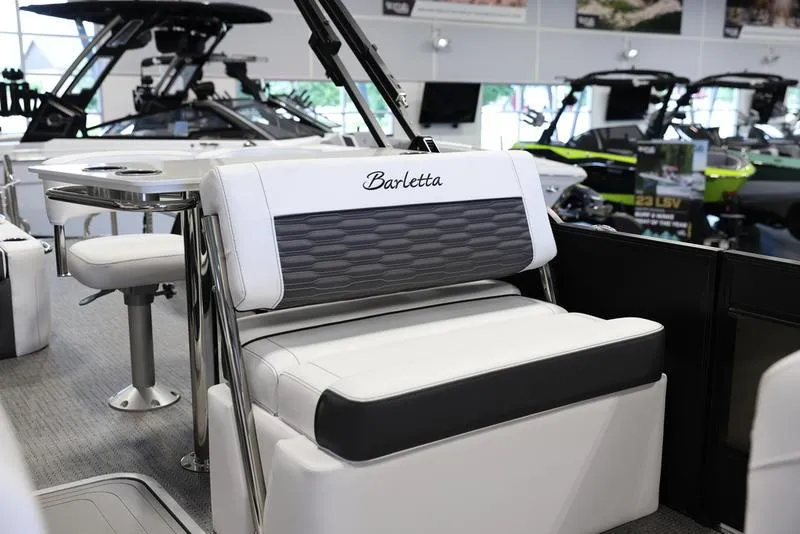 Slide: The Image of 2024 Barletta CORSA 25UE luxury pontoon boat interior with white and gray seating. - 18