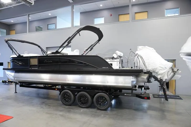 Slide: The Image of 2024 Barletta CORSA 25UE pontoon boat on a trailer in a showroom. - 4