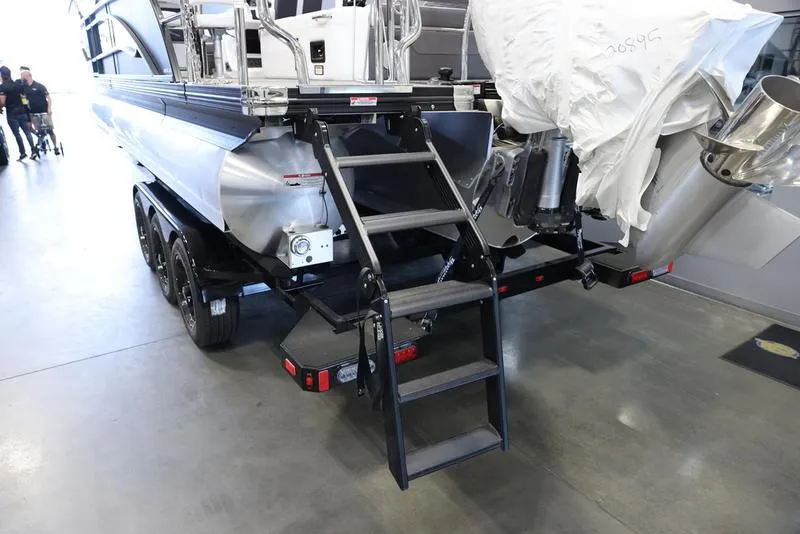 Slide: The Image of 2024 Barletta CORSA 25UE pontoon boat rear view with trailer and ladder. - 5