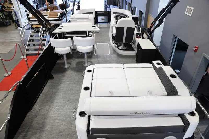Slide: The Image of 2024 Barletta CORSA 25UE luxury pontoon boat interior with seating and tables. - 7