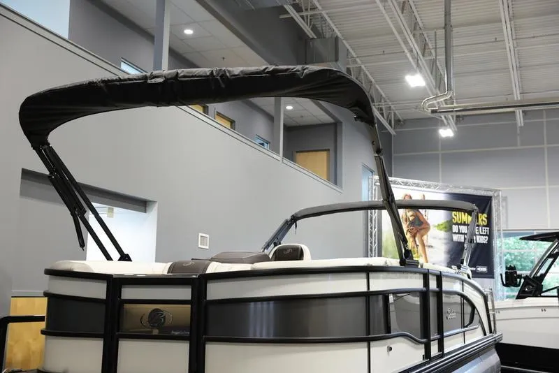 Slide: The Image of 2024 Barletta LUSSO L25M pontoon boat displayed indoors. - 10
