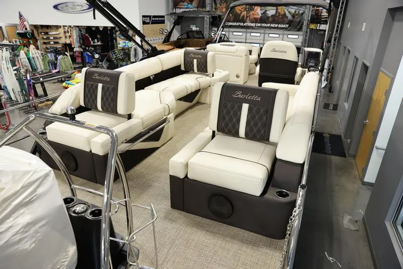 Slide: The Image of 2024 Barletta LUSSO L25M luxury pontoon boat interior with plush seating. - 12
