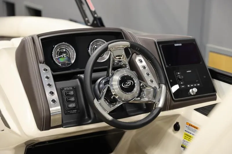 Slide: The Image of 2024 Barletta LUSSO L25M boat dashboard with steering wheel and control panel. - 17