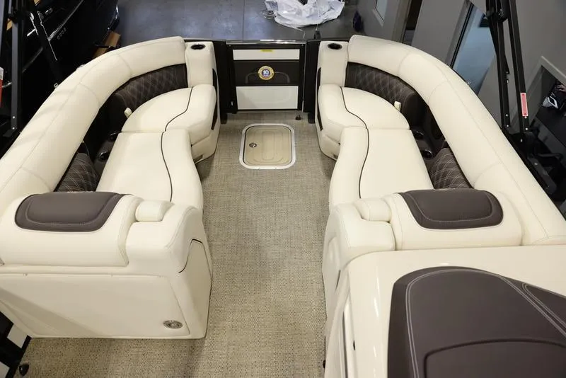 Slide: The Image of 2024 Barletta LUSSO L25M boat interior with luxurious seating and carpeted flooring. - 18