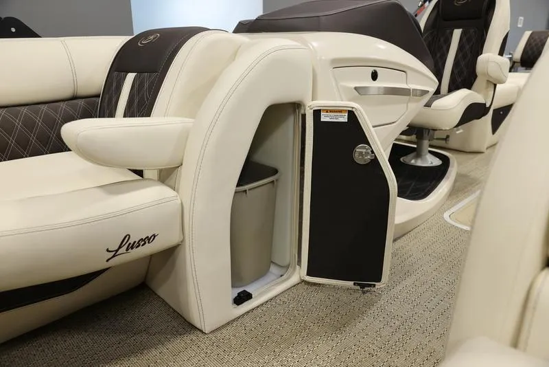 Slide: The Image of 2024 Barletta LUSSO L25M interior with open storage compartment and luxurious seating. - 22