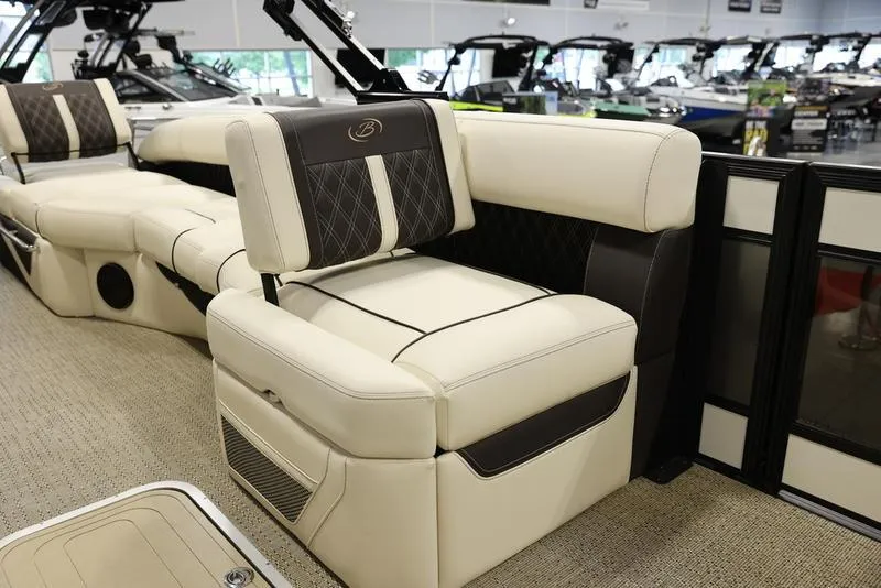 Slide: The Image of Luxurious seating on the 2024 Barletta LUSSO L25M pontoon boat in showroom. - 26