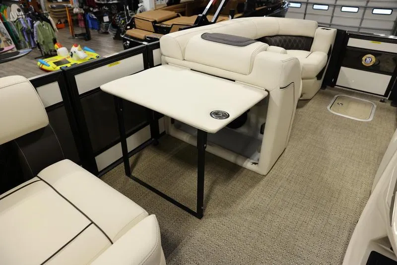 Slide: The Image of 2024 Barletta LUSSO L25M interior with beige seating and foldable table. - 29