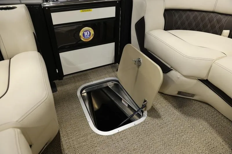 Slide: The Image of 2024 Barletta LUSSO L25M interior storage compartment with beige seating and carpet. - 30