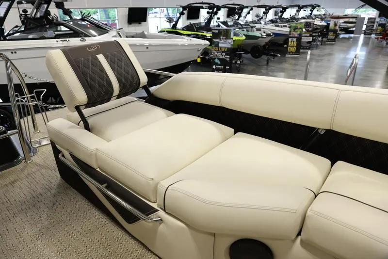 Slide: The Image of 2024 Barletta LUSSO L25M luxury boat interior with plush seating in showroom. - 32