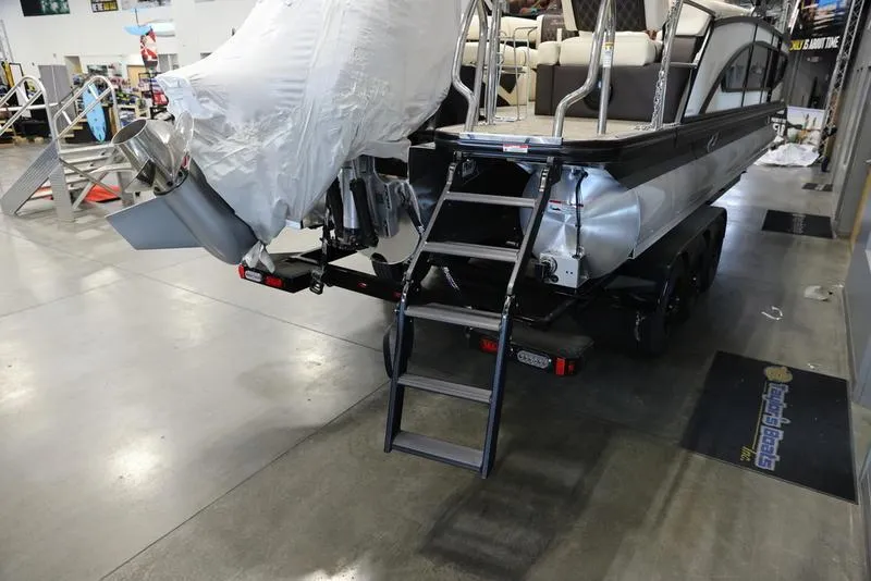 Slide: The Image of 2024 Barletta LUSSO L25M pontoon boat rear view with ladder in showroom. - 6